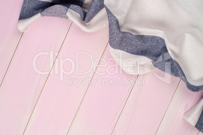 White and blue towel over wooden table