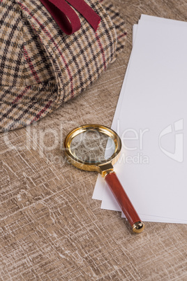 Paper sheets and magnifying glass