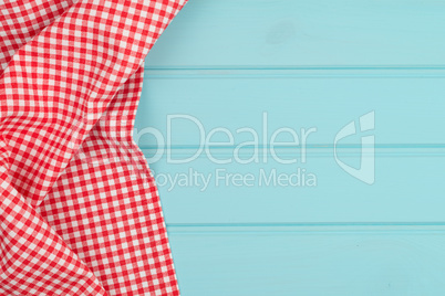 White and red towel over wooden table