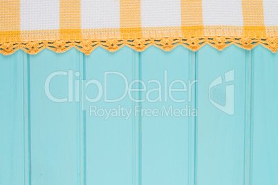 White and yellow towel over wooden table