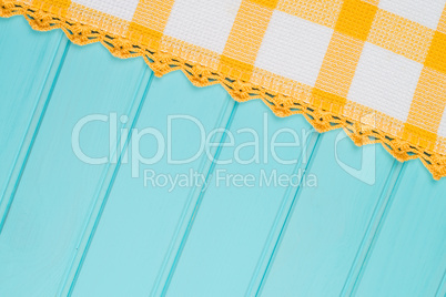 White and yellow towel over wooden table