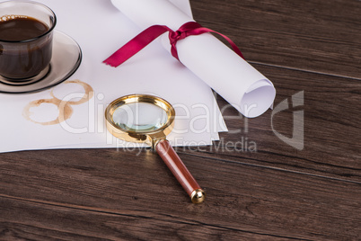 Wrapped paper sheets and magnifying glass