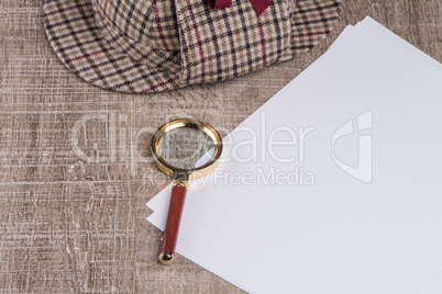 Paper sheets and magnifying glass