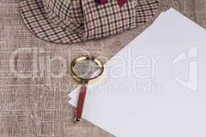 Paper sheets and magnifying glass
