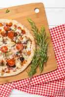 Pizza with bacon, olives and tomato