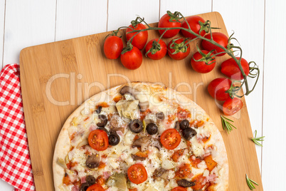 Pizza with bacon, olives and tomato