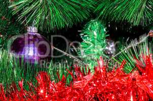 Shabby ball and tinsel on artificial Christmas tree