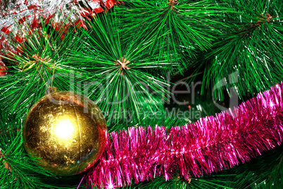 Shabby ball and tinsel on artificial Christmas tree