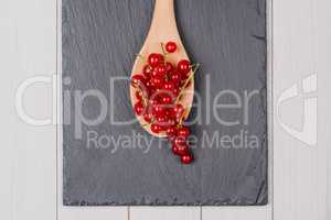 Currants in a wooden spoon