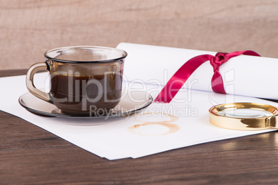 Coffee cup, paper sheets and detective hat