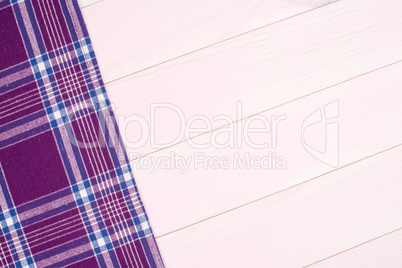 Purple towel over wooden table Purple towel over wooden table