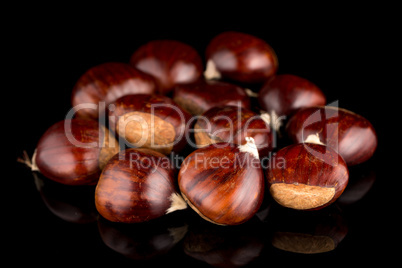 Chestnuts on a black reflective background