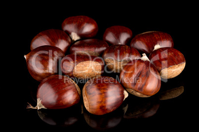 Chestnuts on a black reflective background