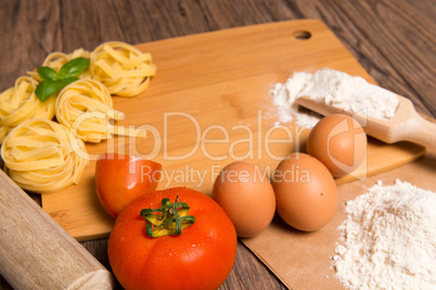 Raw pasta, tomato and eggs