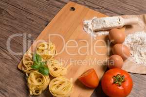 Raw pasta, tomato and eggs