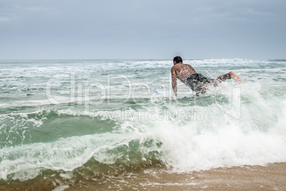 Surfer entering the water