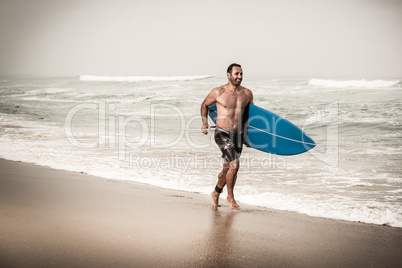 Surfer running on the beach