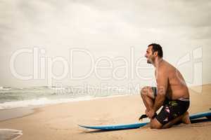 Surfer tying his surfboard's leach