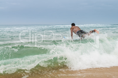 Surfer entering the water