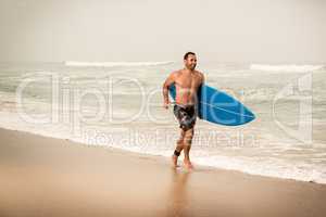 Surfer running on the beach