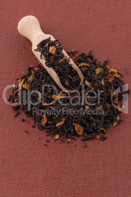 Black Dry Tea with a Wooden Spoon