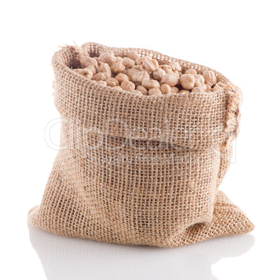 Uncooked chickpeas on burlap bag