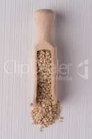 Wooden scoop with sesame seeds