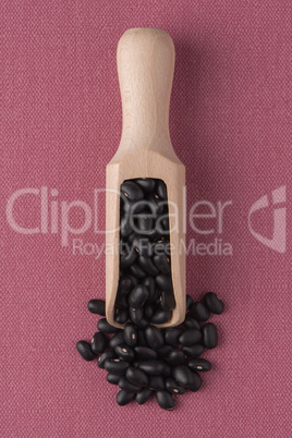 Wooden scoop with black beans