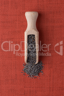 Wooden scoop with poppy seeds