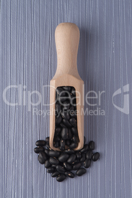 Wooden scoop with black beans