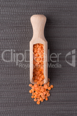 Wooden scoop with  peeled lentils