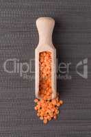 Wooden scoop with  peeled lentils