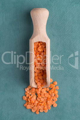 Wooden scoop with  peeled lentils