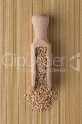 Wooden scoop with sesame seeds