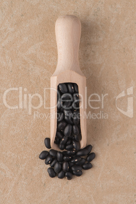 Wooden scoop with black beans