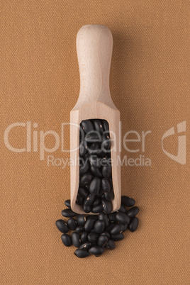 Wooden scoop with black beans