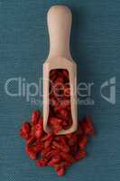 Wooden scoop with dry red goji berries