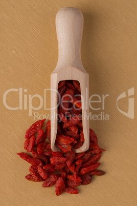 Wooden scoop with dry red goji berries