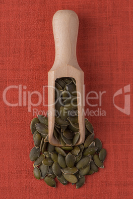 Wooden scoop with pumpkin seeds