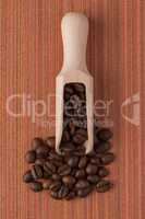 Wooden scoop with coffee beans