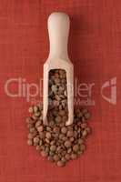 Wooden scoop with lentils