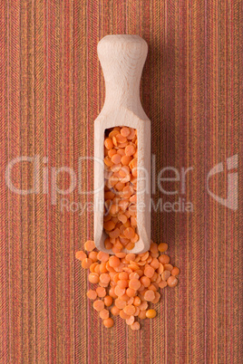 Wooden scoop with  peeled lentils