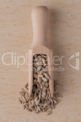 Wooden scoop with shelled sunflower seeds