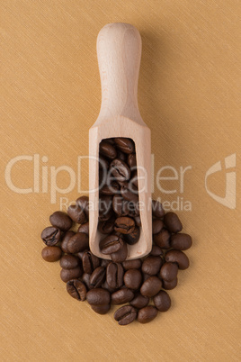 Wooden scoop with coffee beans