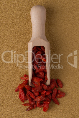 Wooden scoop with dry red goji berries