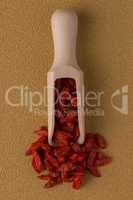 Wooden scoop with dry red goji berries