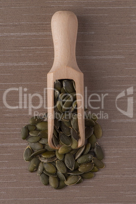 Wooden scoop with pumpkin seeds