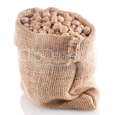 Uncooked chickpeas on burlap bag