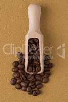 Wooden scoop with coffee beans