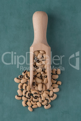 Wooden scoop with white beans